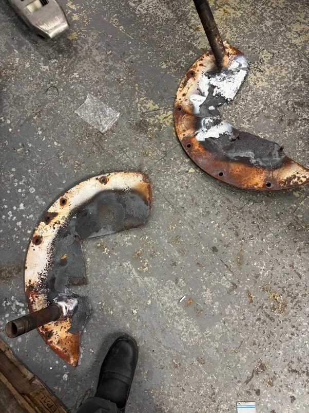 Removed burner faceplate showing severe deterioration.