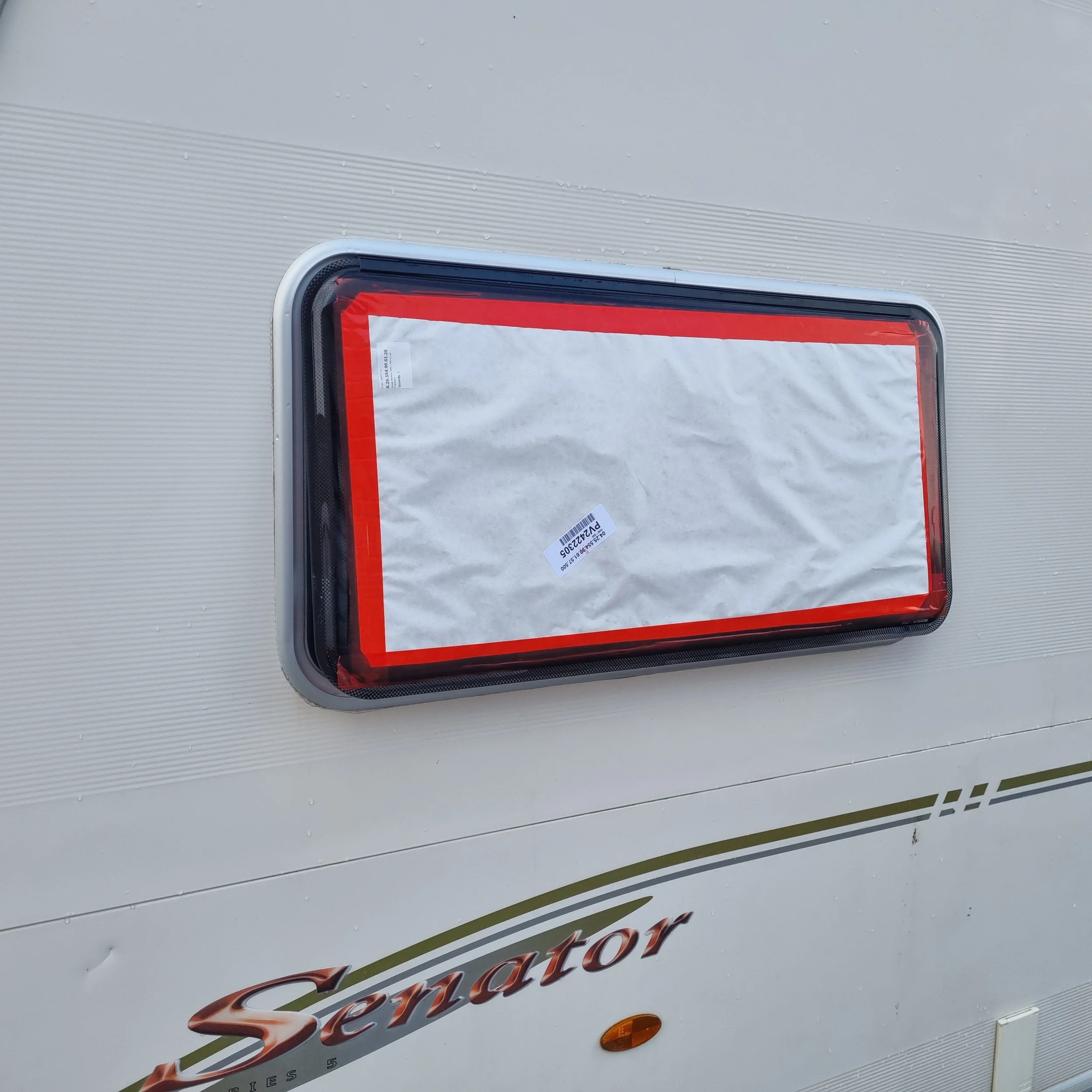 Installing the replacement window into the caravan hinge channel