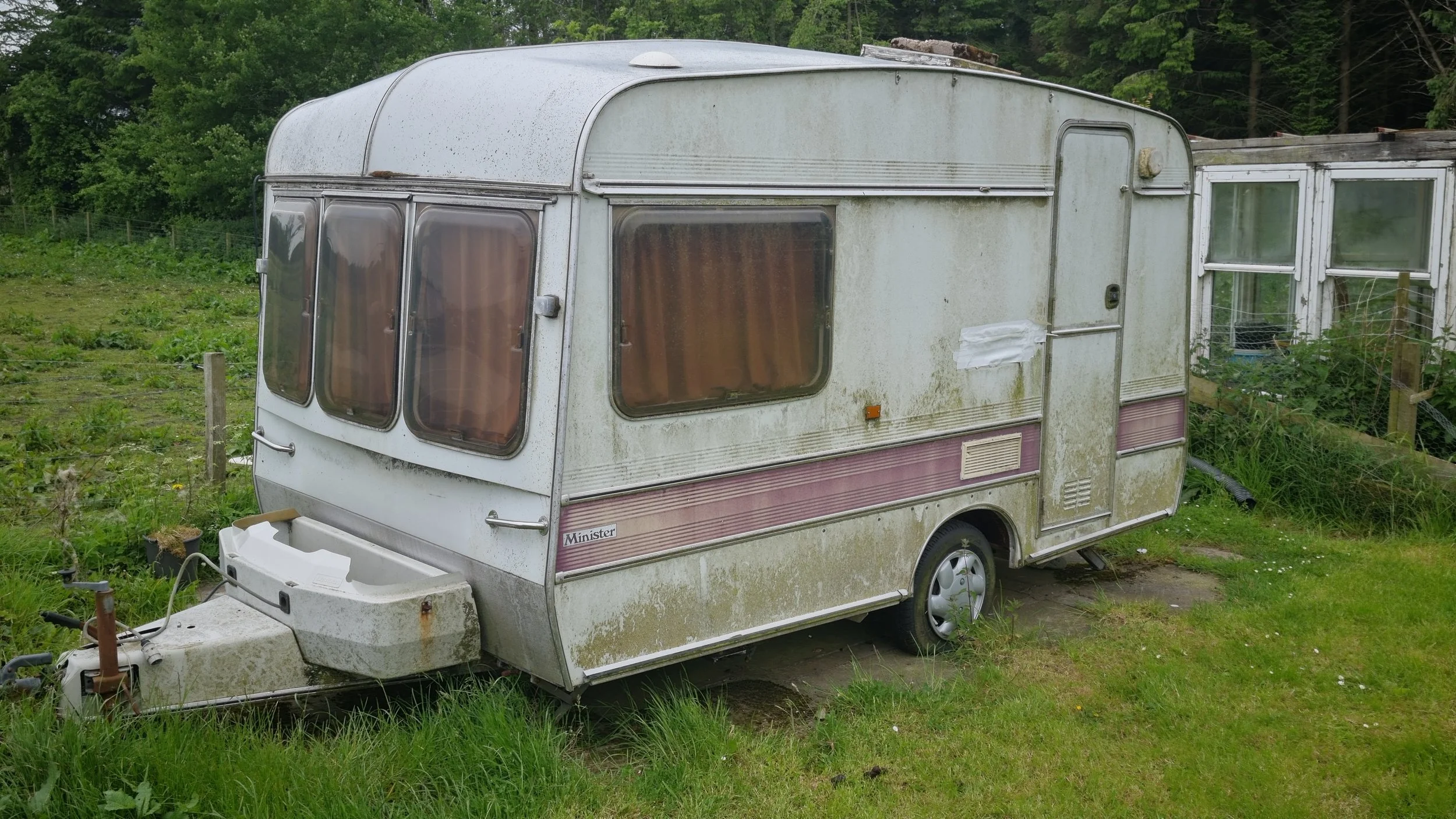 Side profile of the classic 1980s Churchill Minster caravan showing weathering