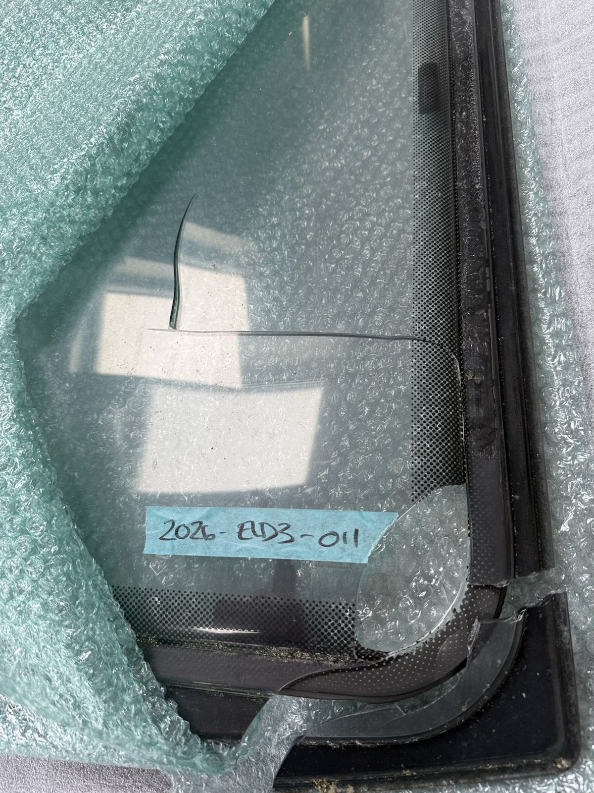 Cracked Polyplastic caravan window ruined by courier transit mishandling