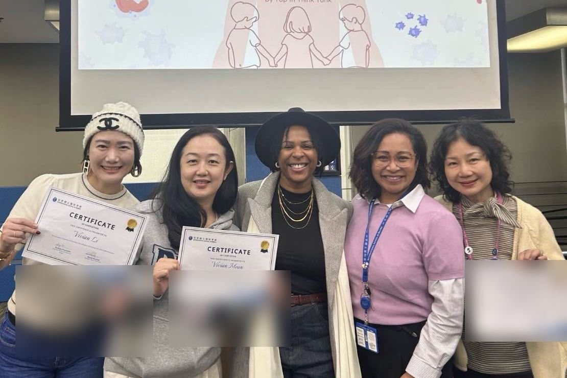 Nicole with ISB parents holding certificates at the close of The Anatomy of Belonging parent workshop series