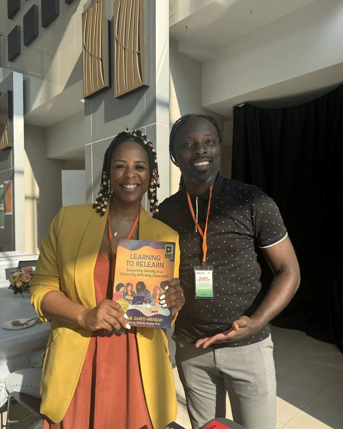 Nicole Bonnah holding Learning to Relearn beside its author, Kwame Sarfo-Mensah