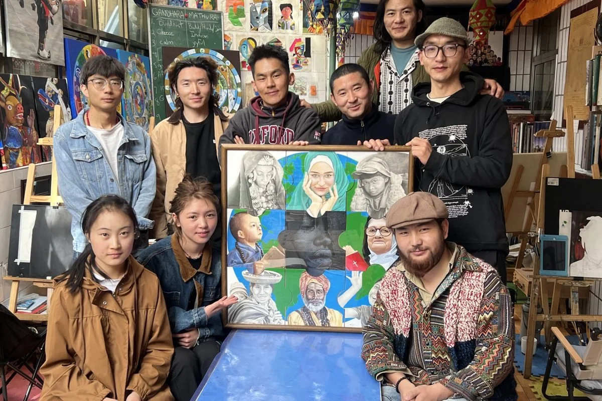 Snowland Arts artists with a collaborative portrait painting
