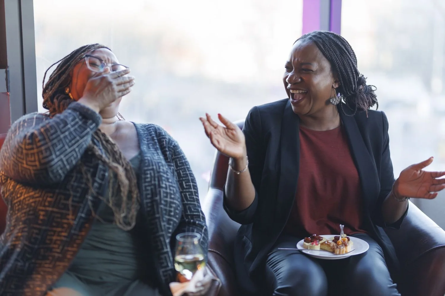 Two women laughing together at a Talks on Tap and REM evening