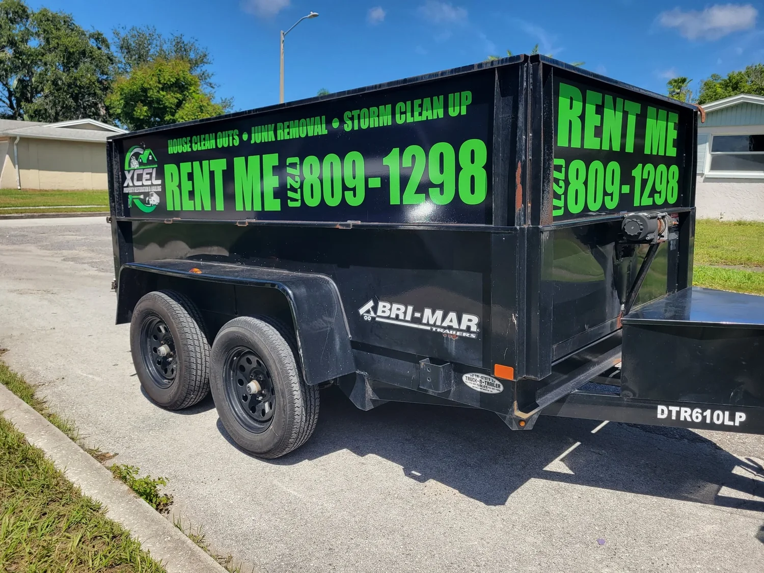 Xcel dump trailer parked on job site