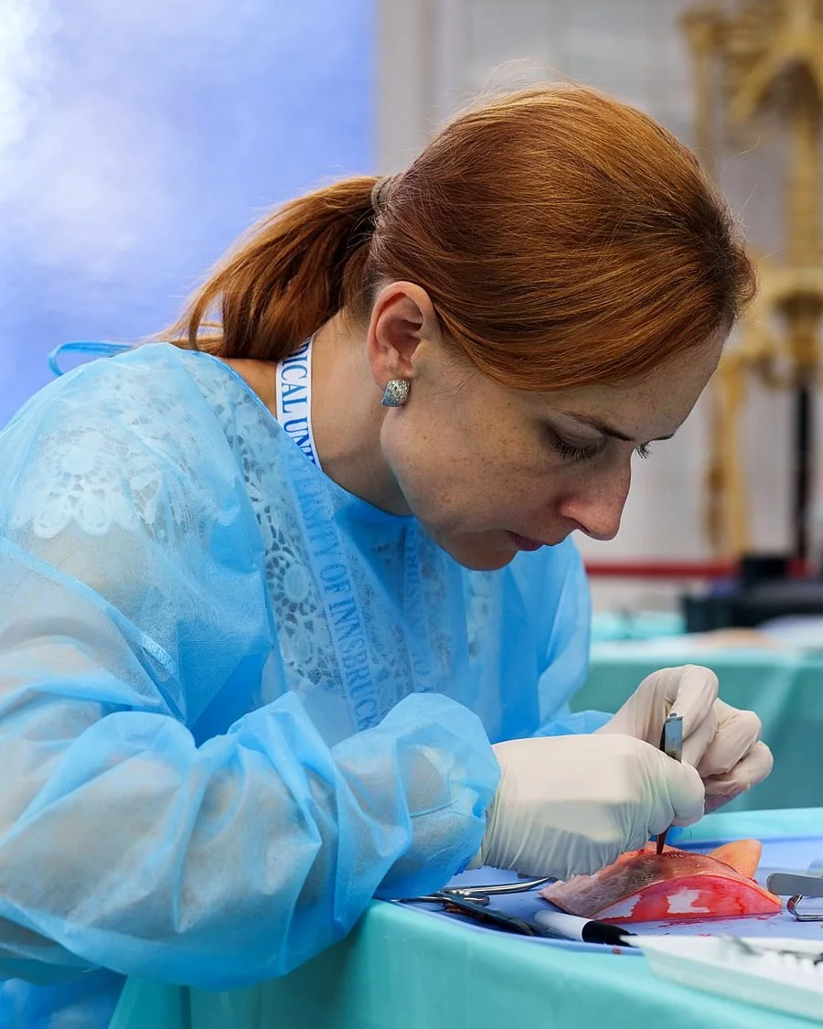 Surgeon concentrating on a suturing exercise during a wetlab
