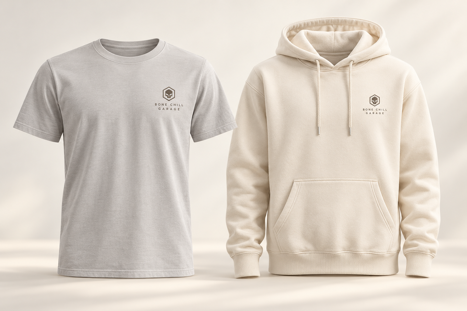 Pearl gray Reserve T-shirt and ivory Reserve hoodie with small tonal skull emblems and fine Bone Chill Garage lettering on the left chest.