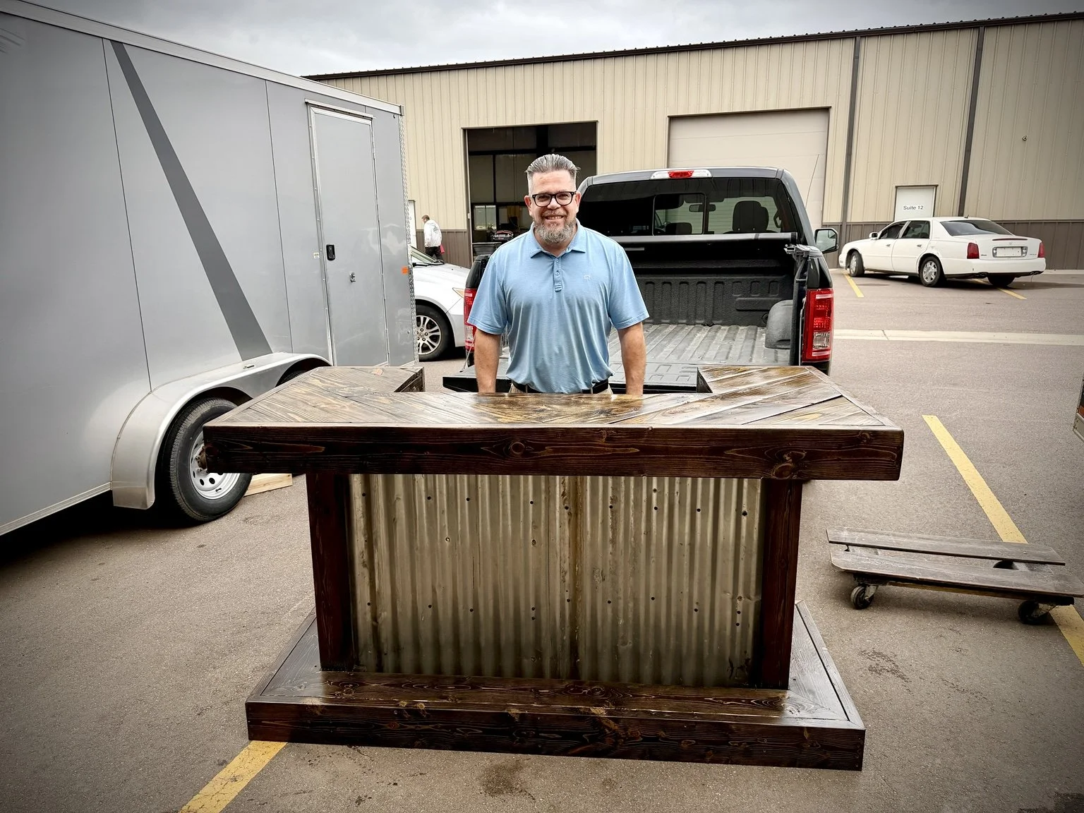 Sioux City customer with a dark wood and corrugated metal bar by Bone Chill Garage