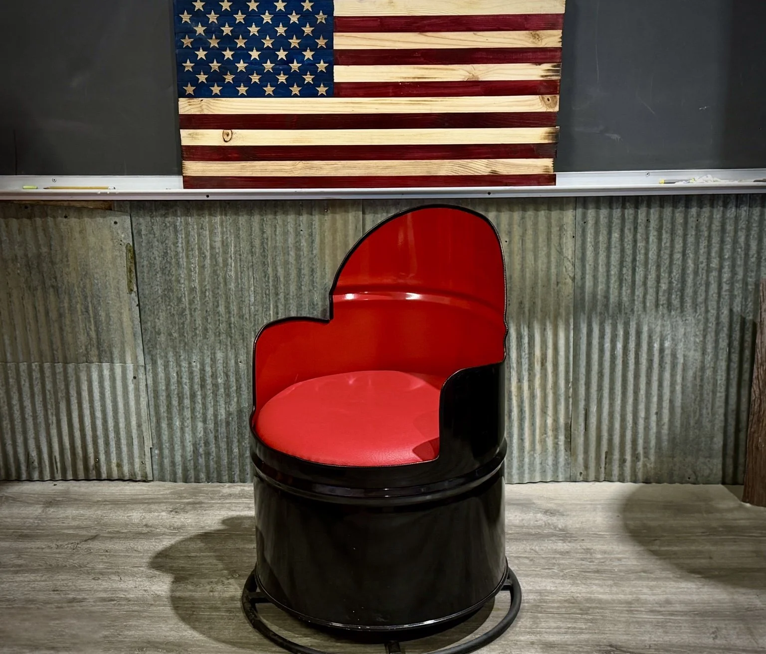 Handcrafted black and red barrel swivel chair by Bone Chill Garage
