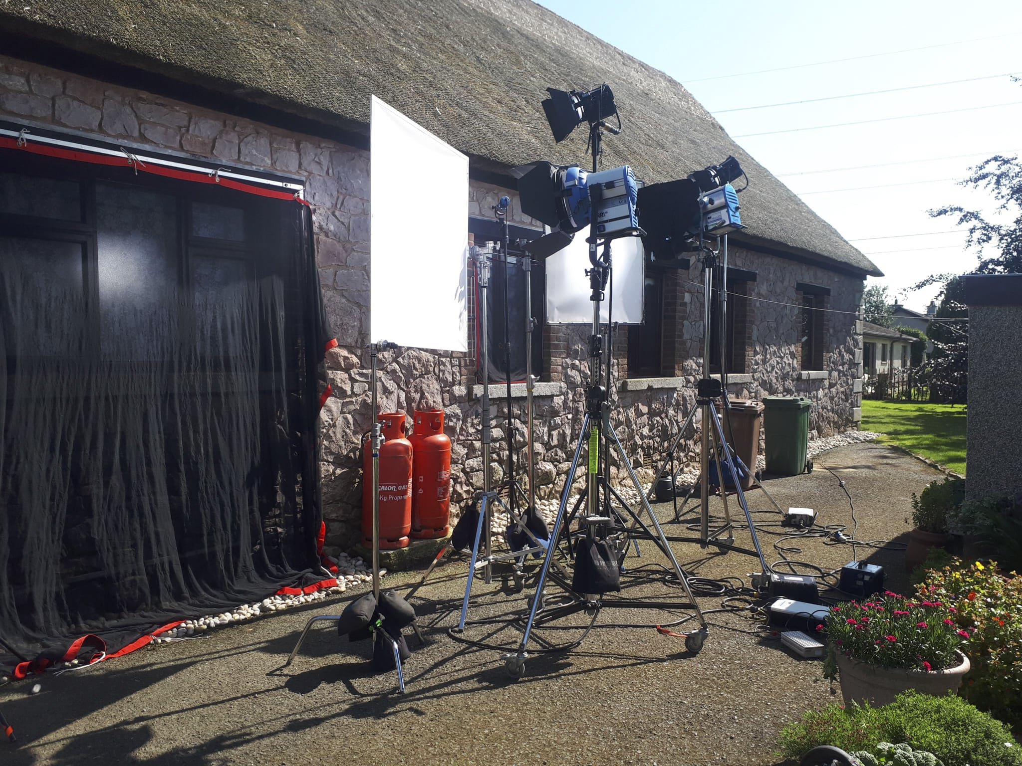 ARRI lights set up outside a cottage on location