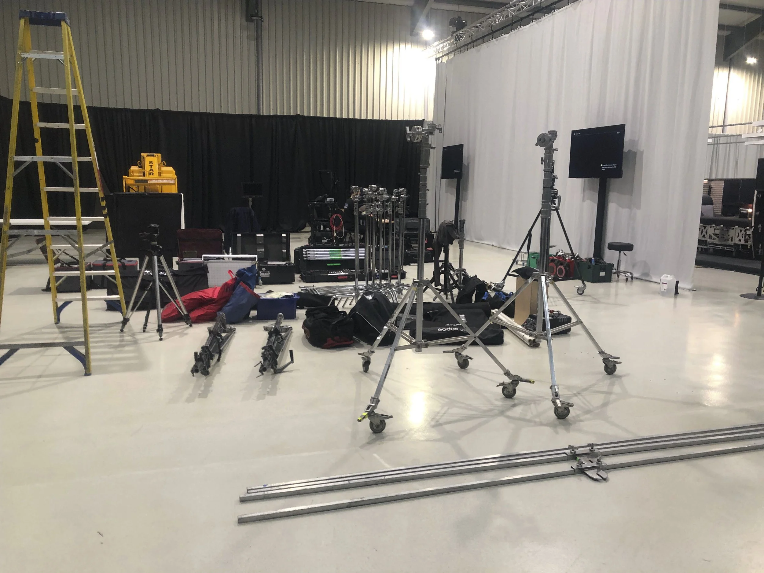 Studio floor laid out with lighting and grip equipment