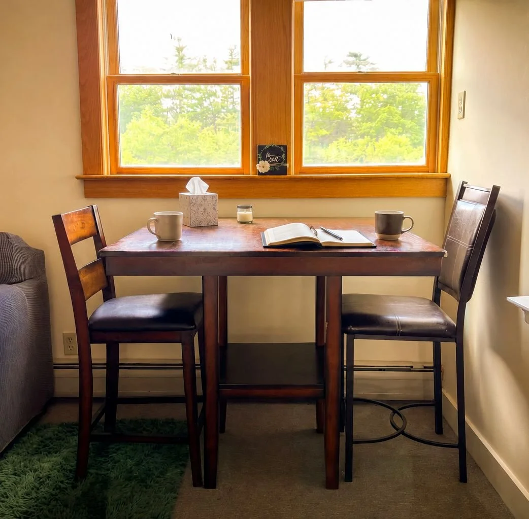 A table and chairs for journaling in the Journaling Room at The Living Room, Henniker NH