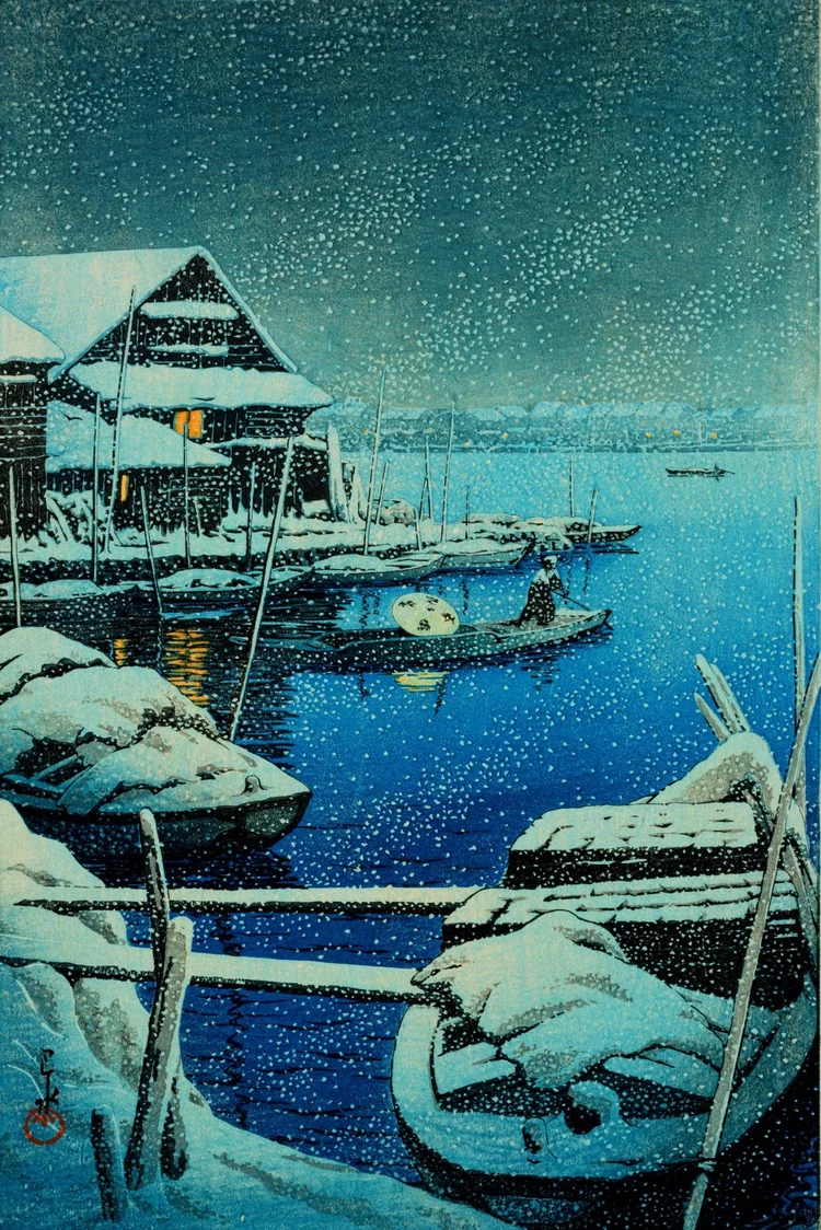 Canvas reprint of Snow at Mukojima by Kawase Hasui: a snow-covered riverside building and boats frame a blue waterway, a small boatman and warm yellow reflections beneath dense falling snow.