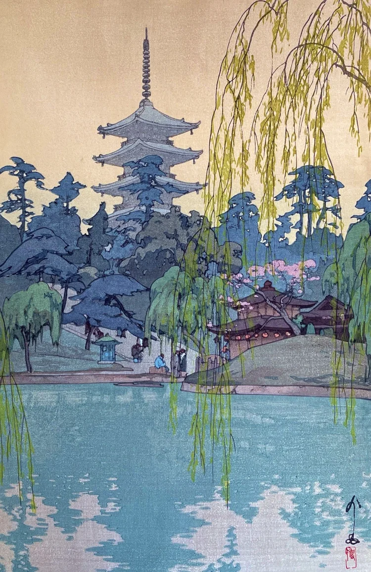 Willow branches frame blue Sarusawa Pond, a pagoda, spring blossoms and small figures in Hiroshi Yoshida’s Nara landscape.