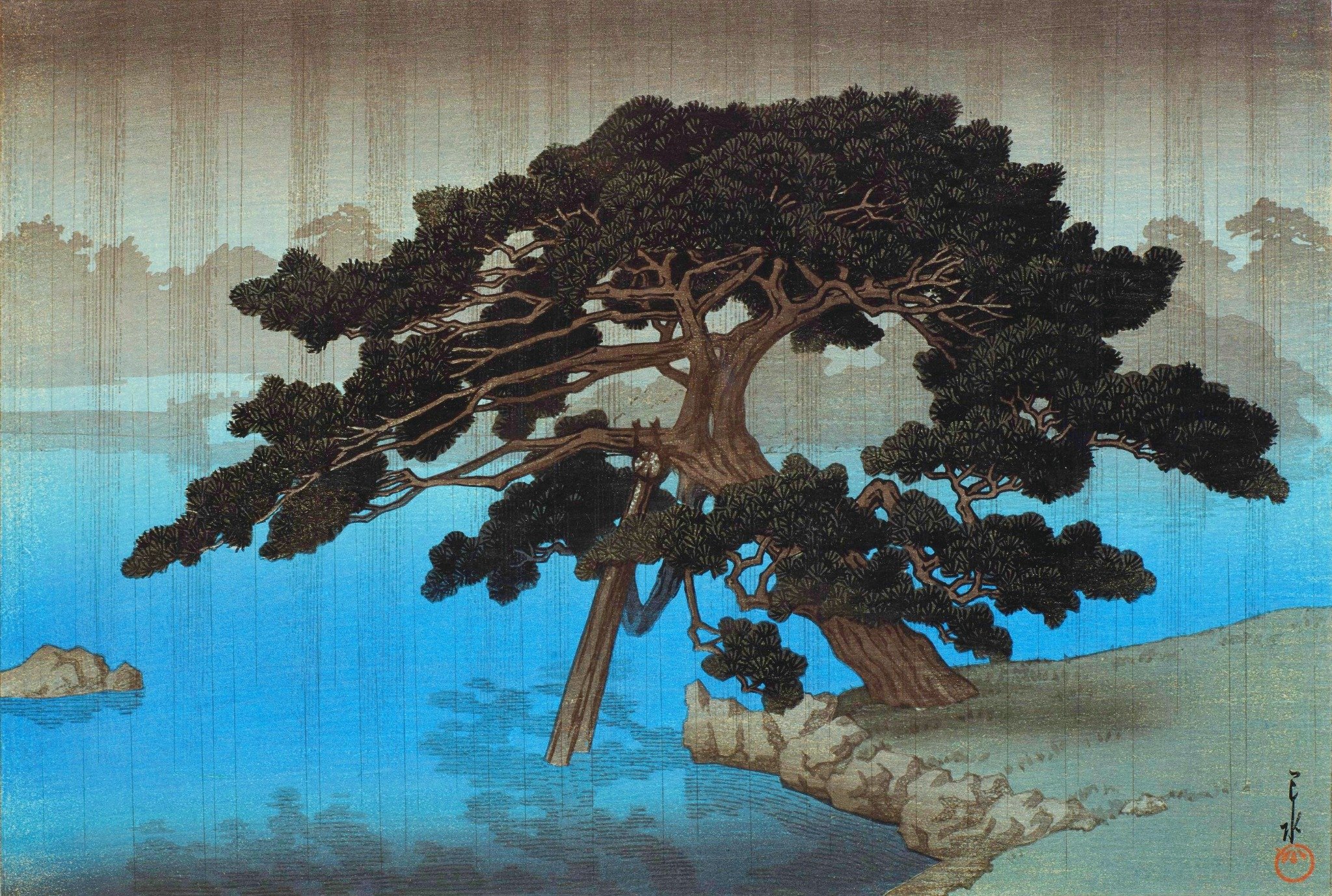 Onshi Park, Shiba by Kawase Hasui: a spreading pine supported by timber beside a stone-edged blue pond, with fine falling rain and distant trees softened by mist.