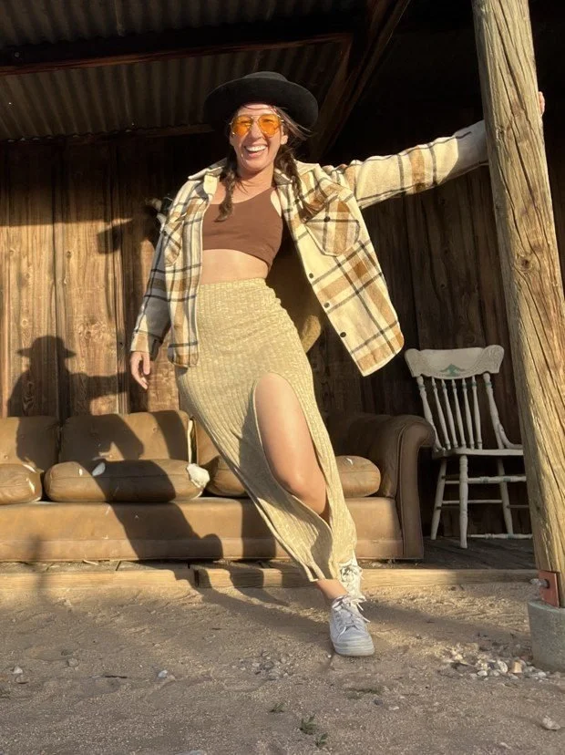Catherine laughing on a desert cabin porch