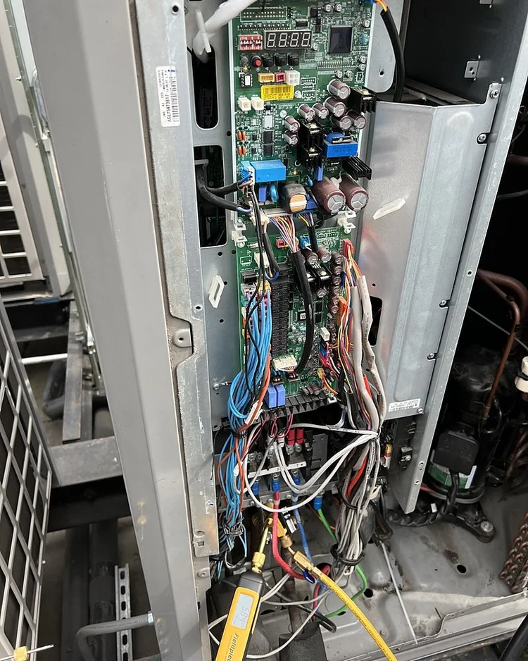 Control board with a status display inside an open VRF outdoor unit