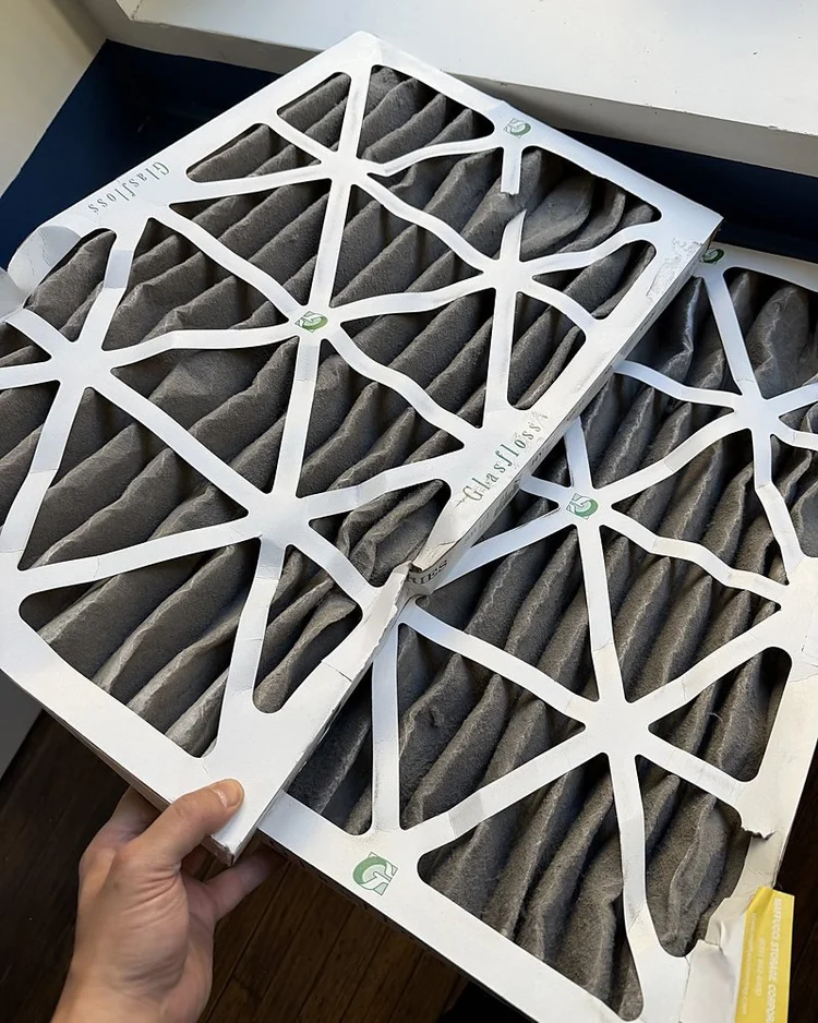 Two pleated air filters loaded with dust