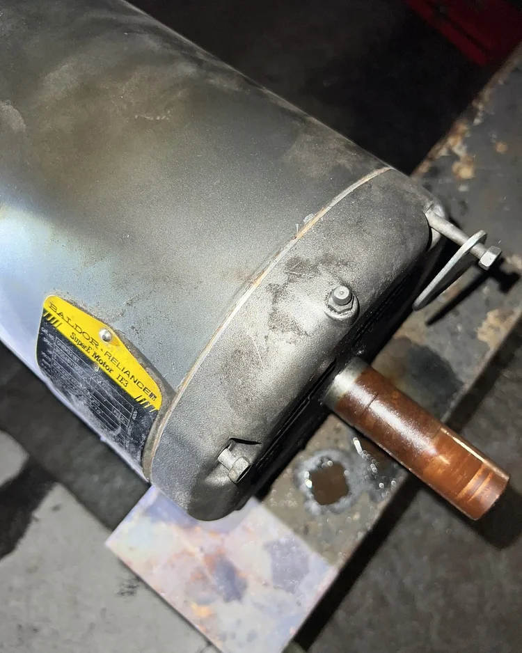 The failed motor after removal, resting on the roof