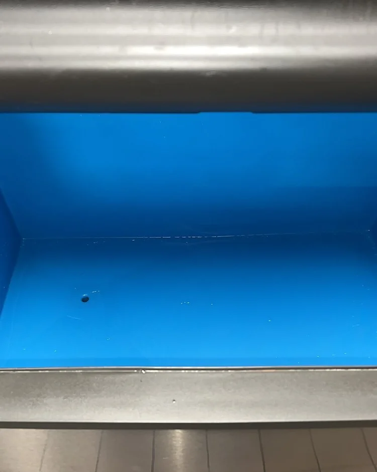 Clean blue ice storage bin after cleaning, with no slime or scale