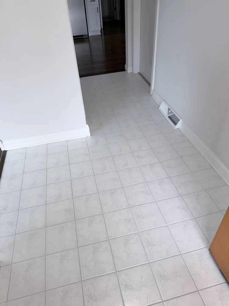 Same light tile hallway after professional cleaning and lighter grout colorsealing