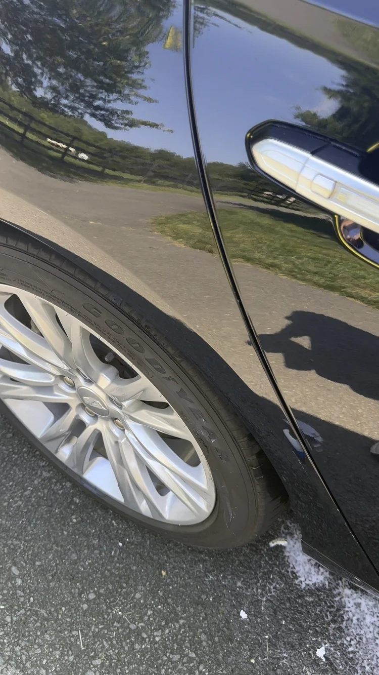 Refined black paint after localized correction, shown as preparation context rather than a ceramic coating result