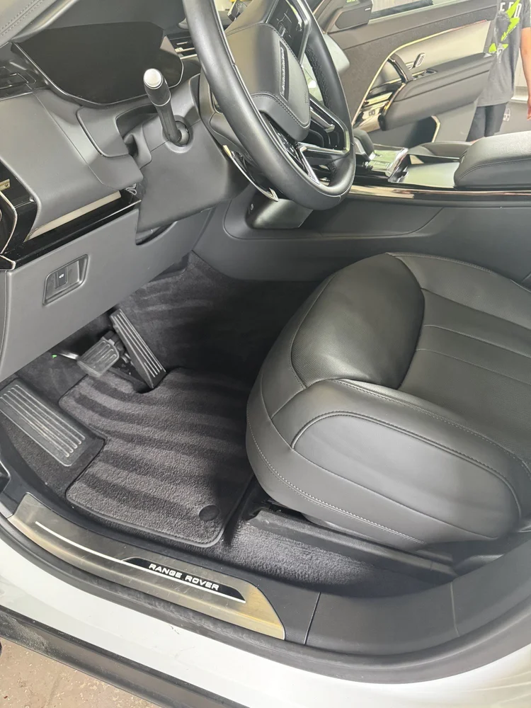 Freshly detailed vehicle interior with clean leather, trim, carpet, and driver area