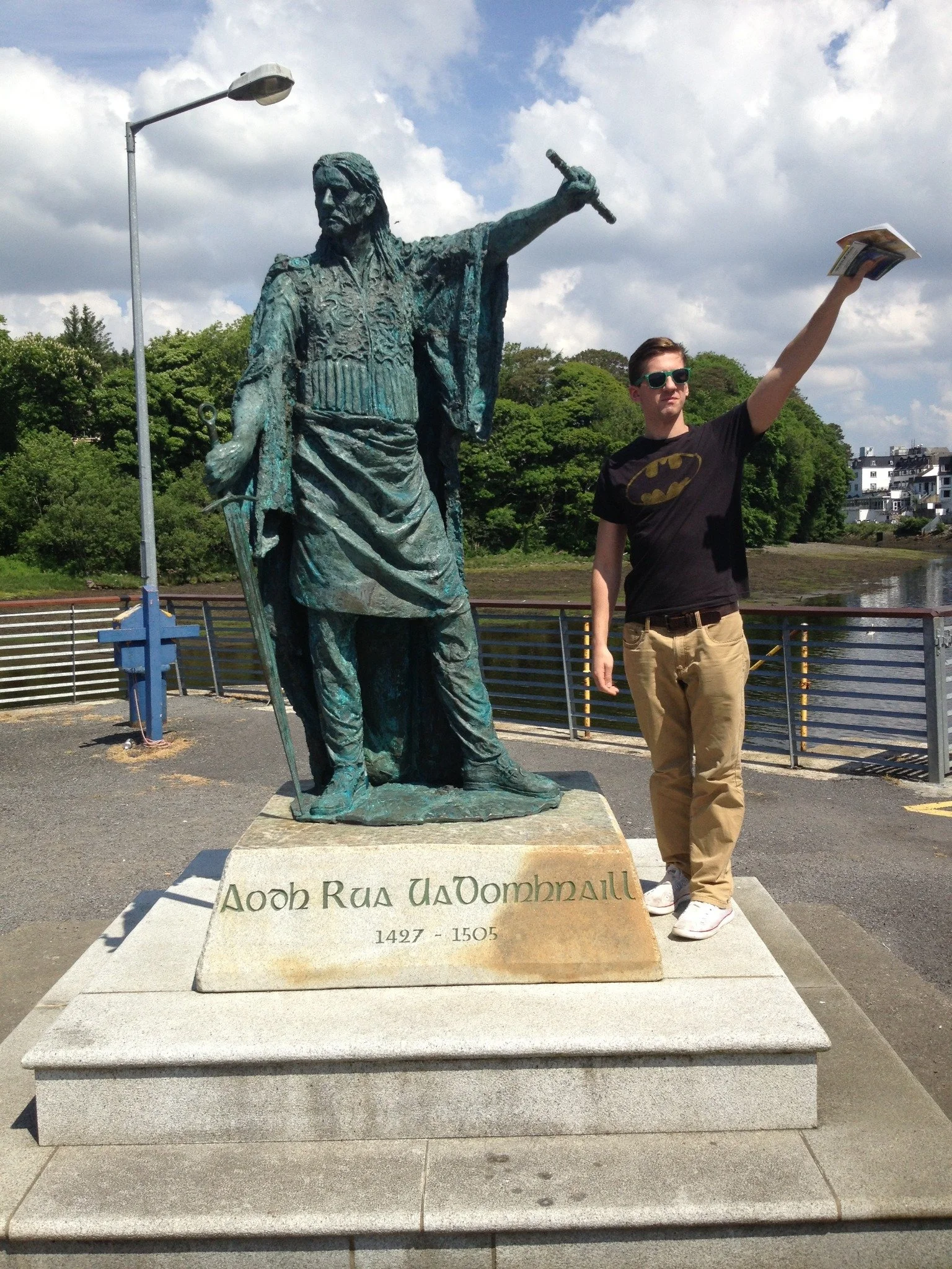 Francis Heschmeyer beside a chieftain’s statue