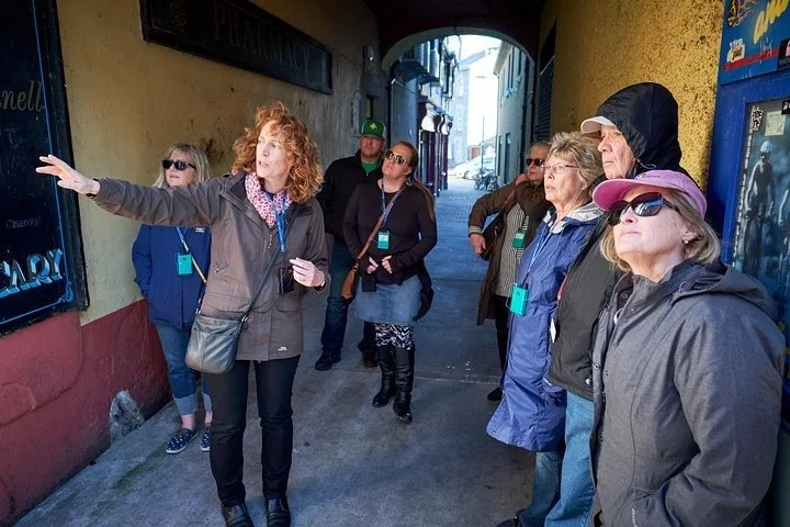 A guided group exploring a colourful passageway in Ennis