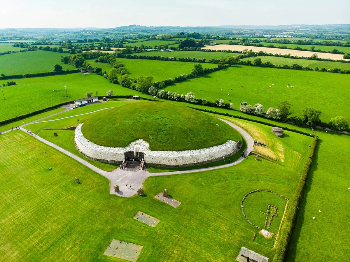 Newgrange surrounded by the green fields of the Boyne Valley