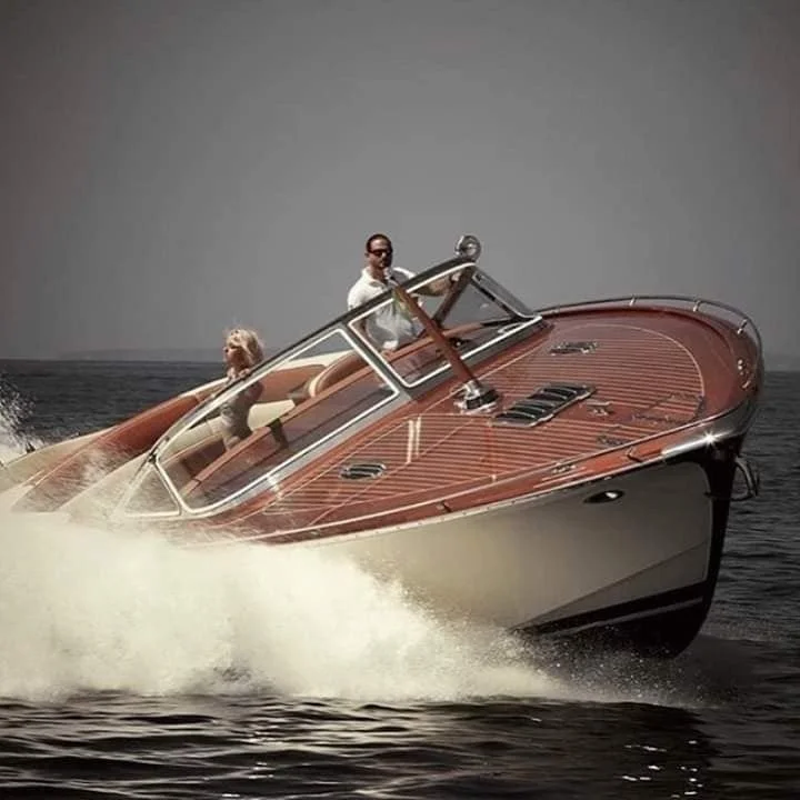 Vintage wooden speedboat at speed on open water