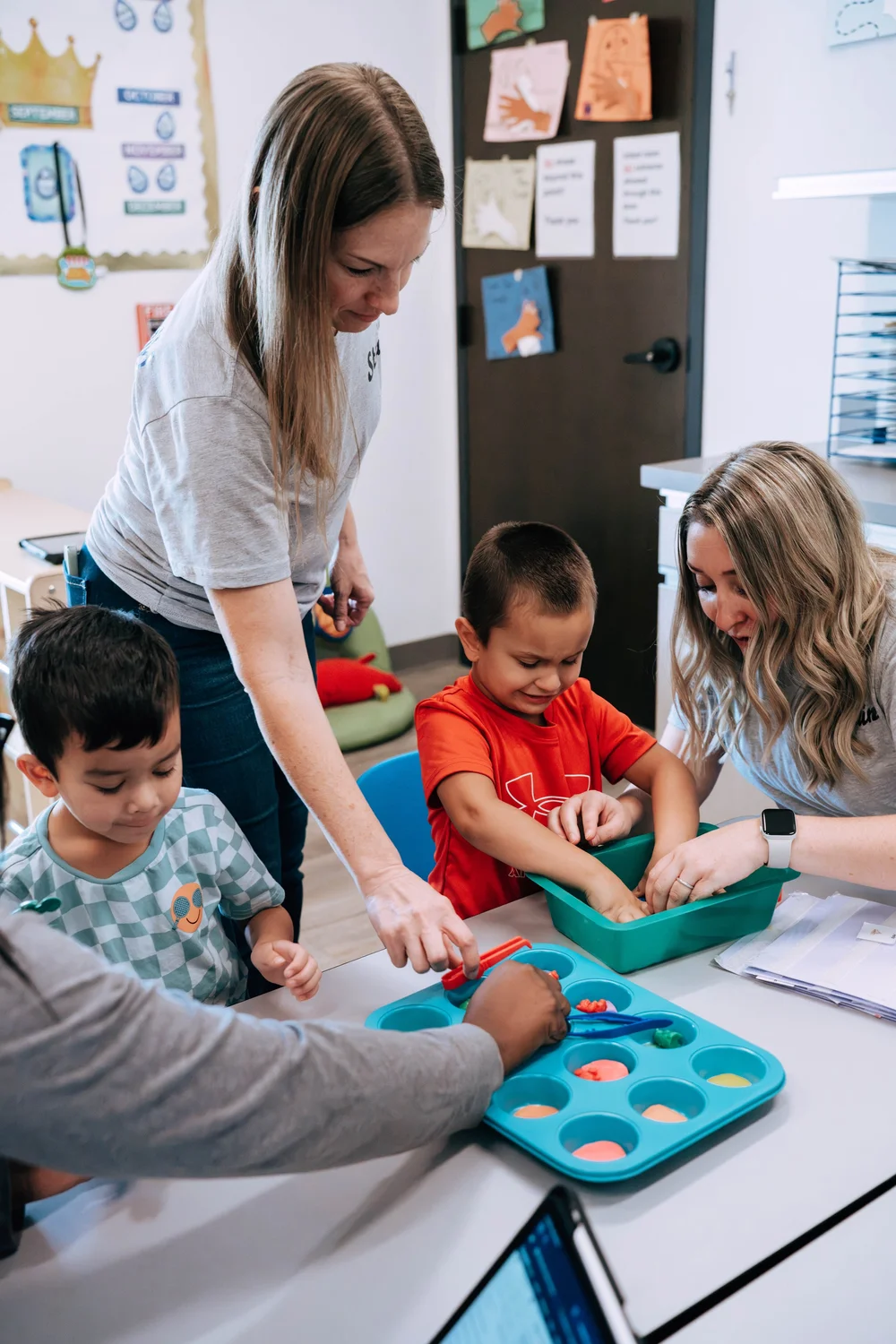Children and staff exploring a hands-on classroom activity