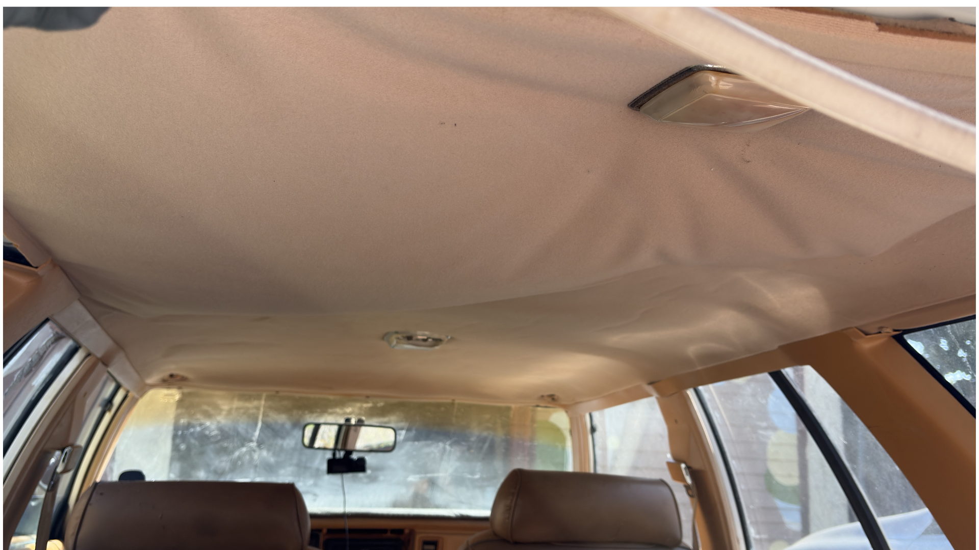 Sagging cloth headliner in a 1985 Chrysler Town and Country wagon before repair