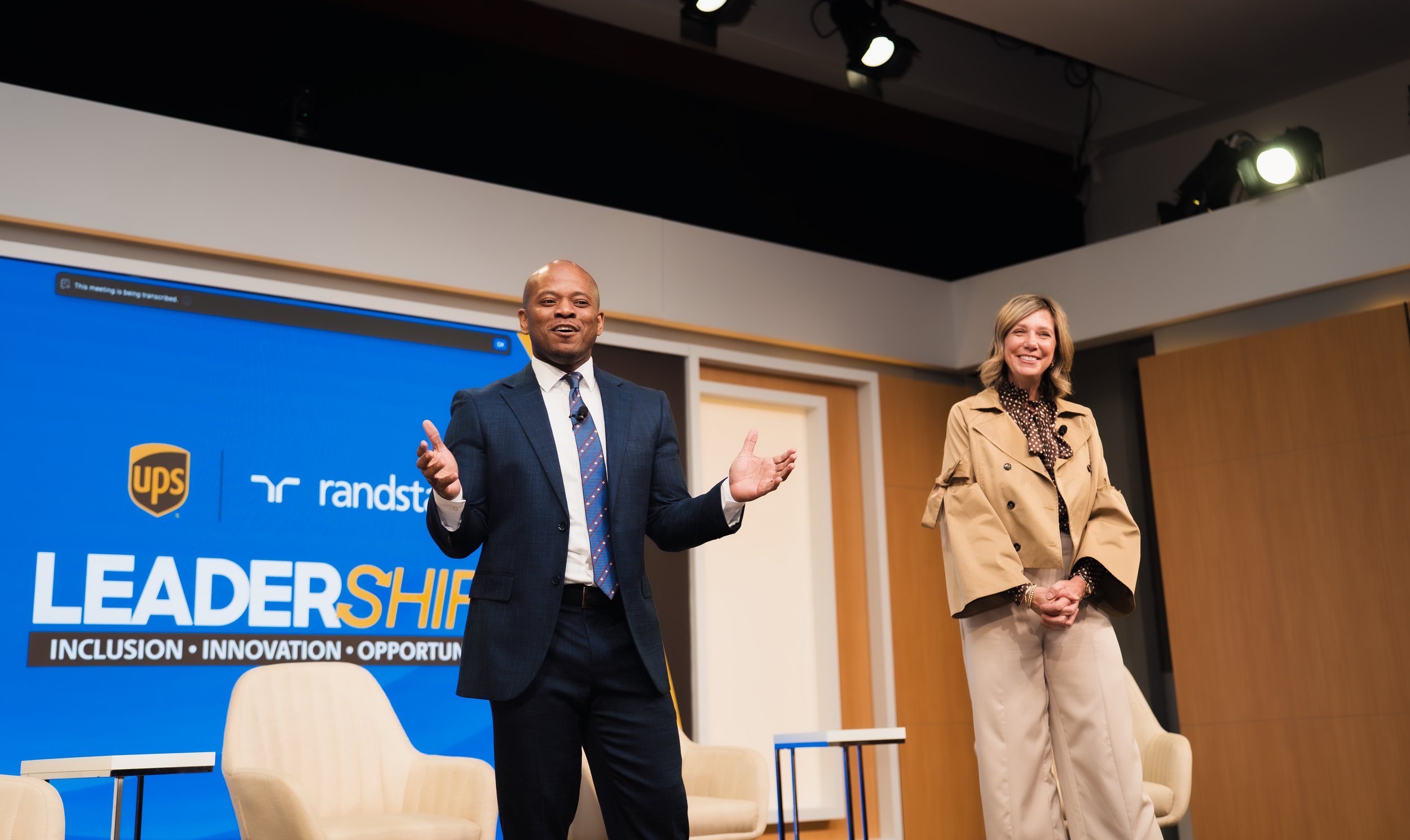Two speakers sharing a warm moment at a UPS leadership event