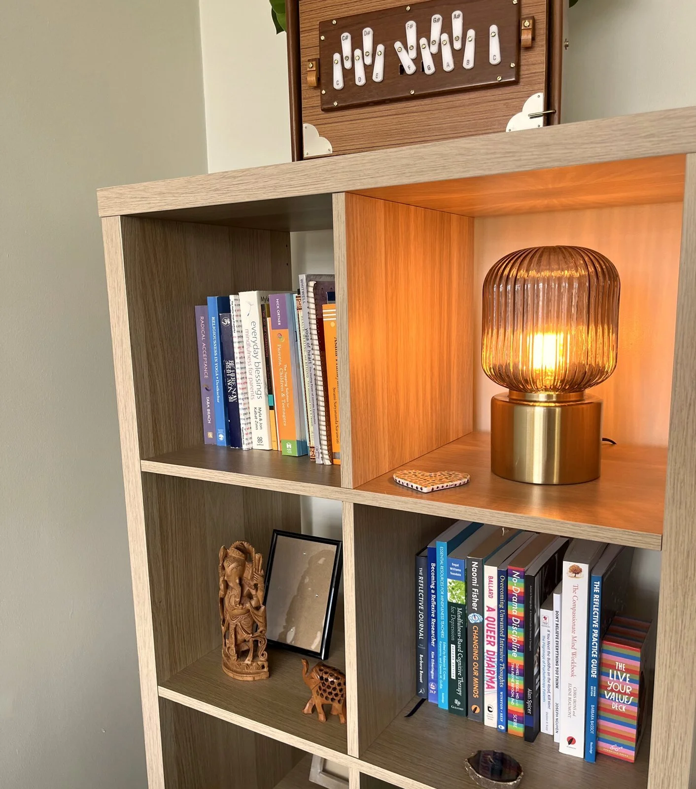 Lamp-lit bookshelf in Angela’s counselling room in Bispham