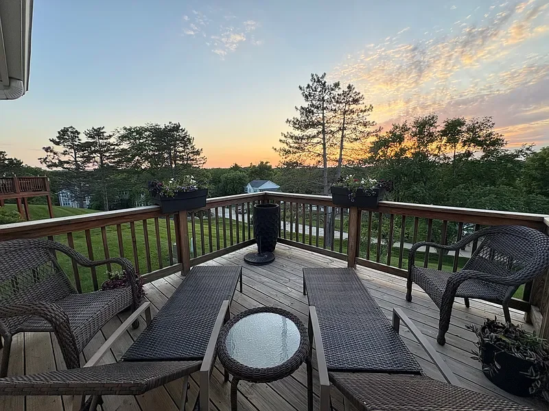 Deck view with mature trees and sunset light