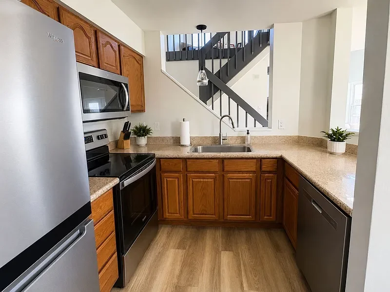 Kitchen with appliances and pass-through view