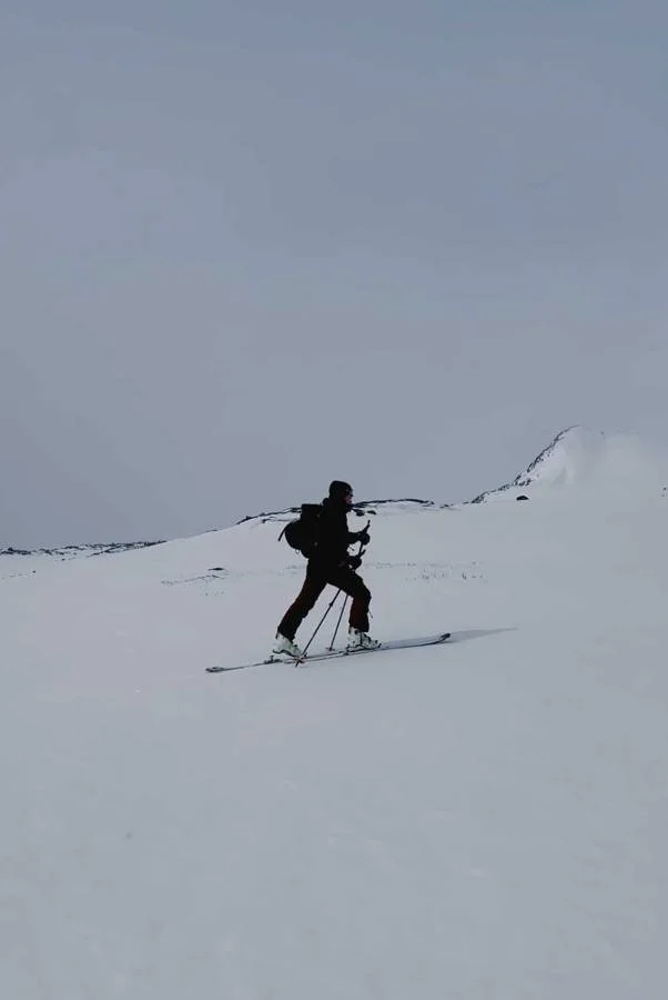 Ski tourer climbing a snowy ridge
