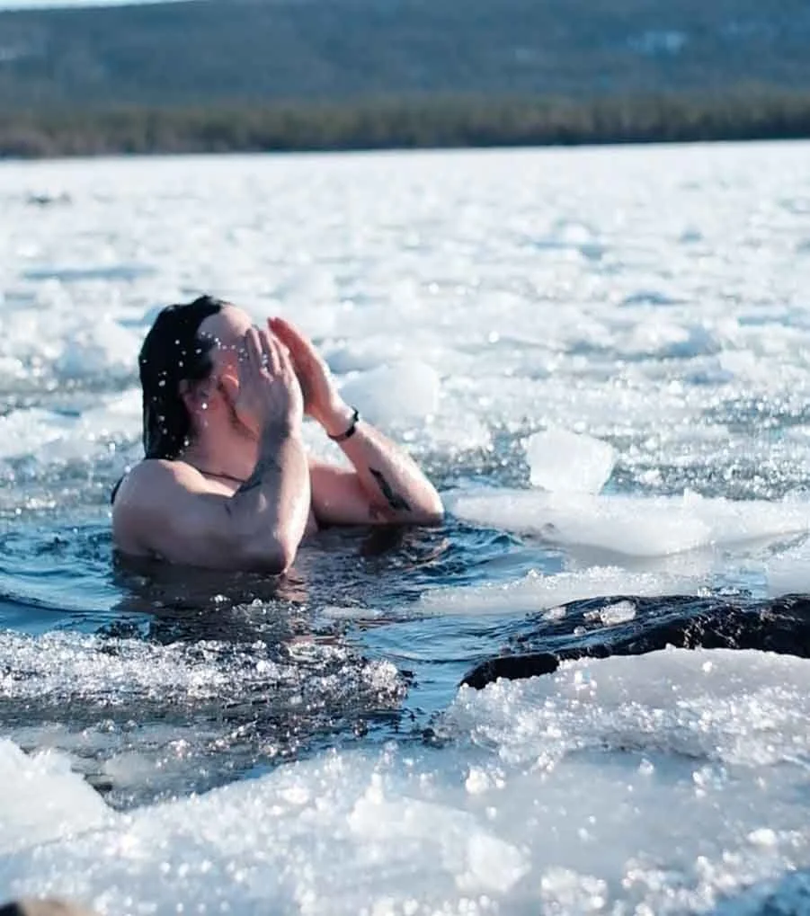 A cold dip among the ice on a frozen lake