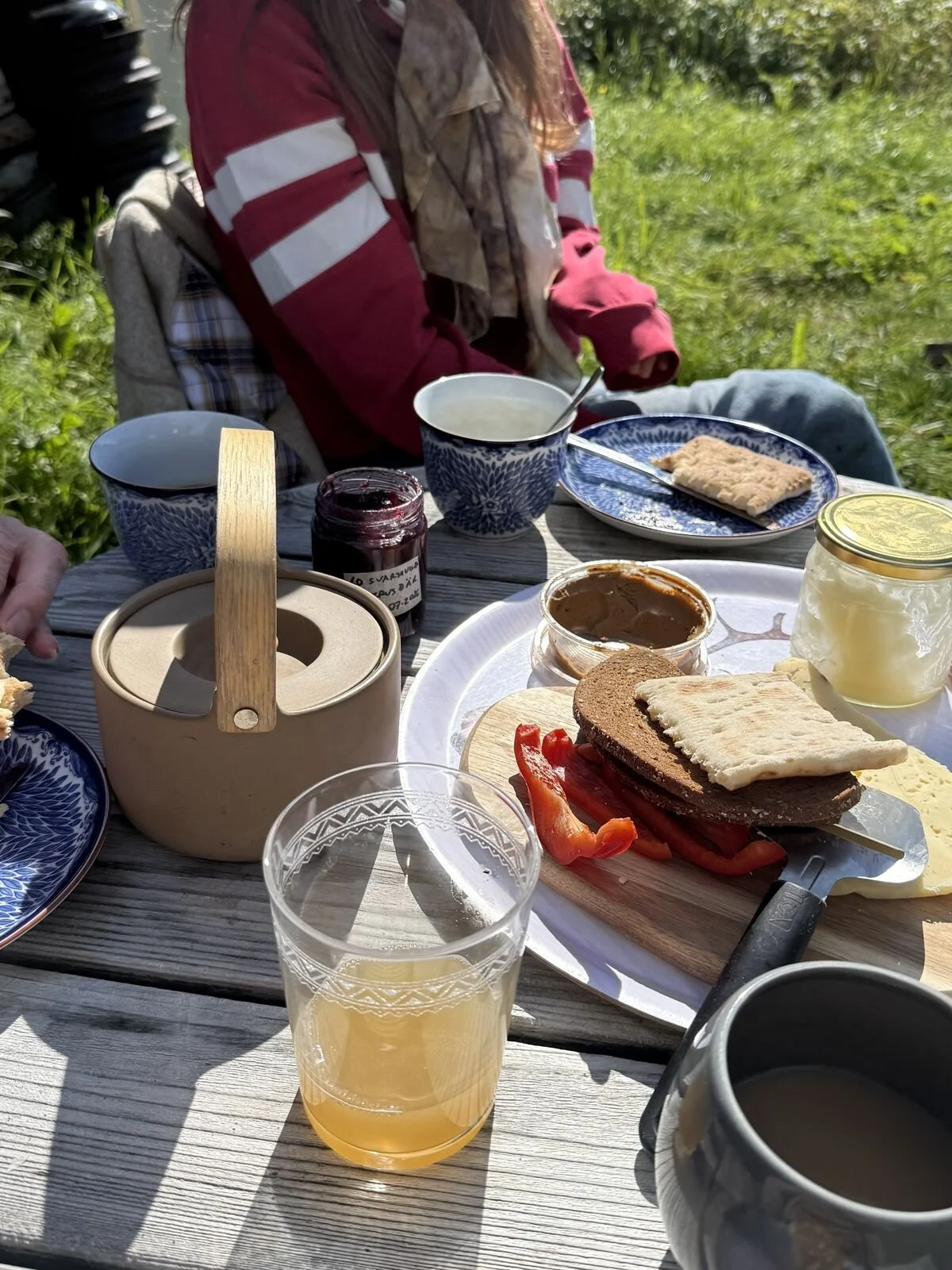 Fika laid out on a wooden table outside