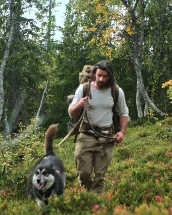 George walking through the forest with his dog