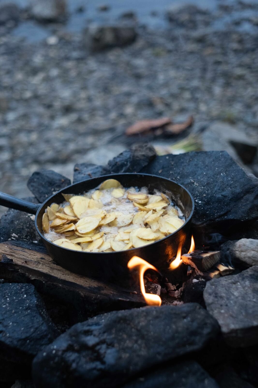 Cooking over the fire by the water