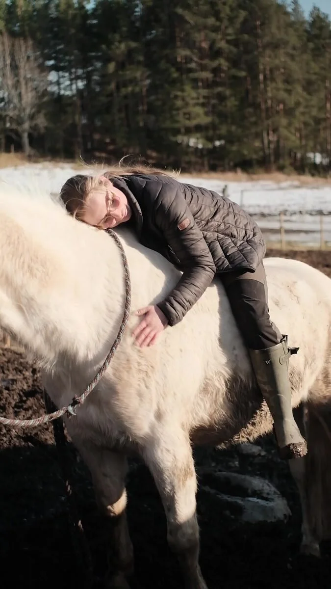 Resting on the back of a white horse