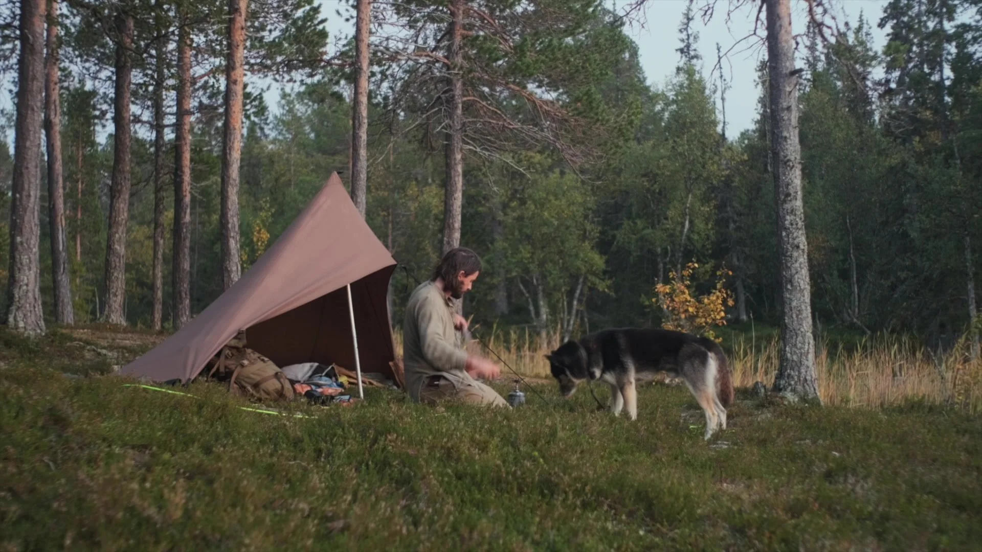 George and his dog at a tarp tent in the forest