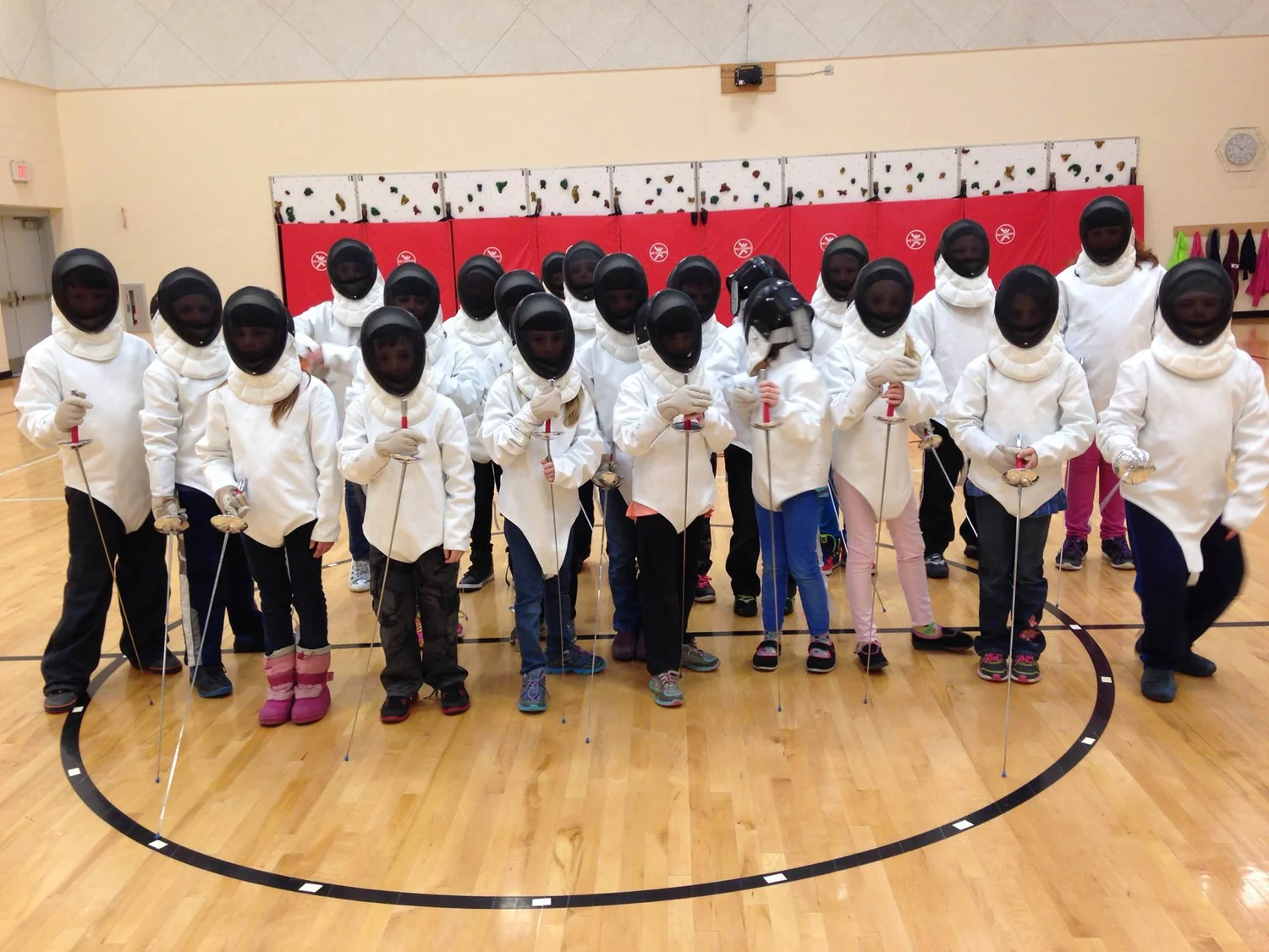 Students fencing in school gym