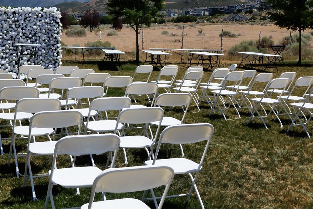 Outdoor wedding ceremony with flower wall
