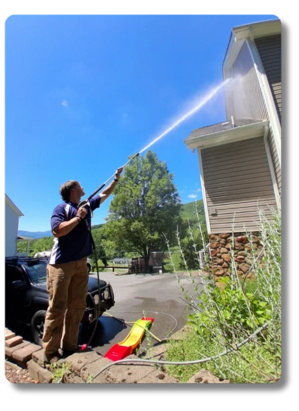 Hot Shot Pressure Washing technician soft washing a house exterior in Roanoke Valley VA