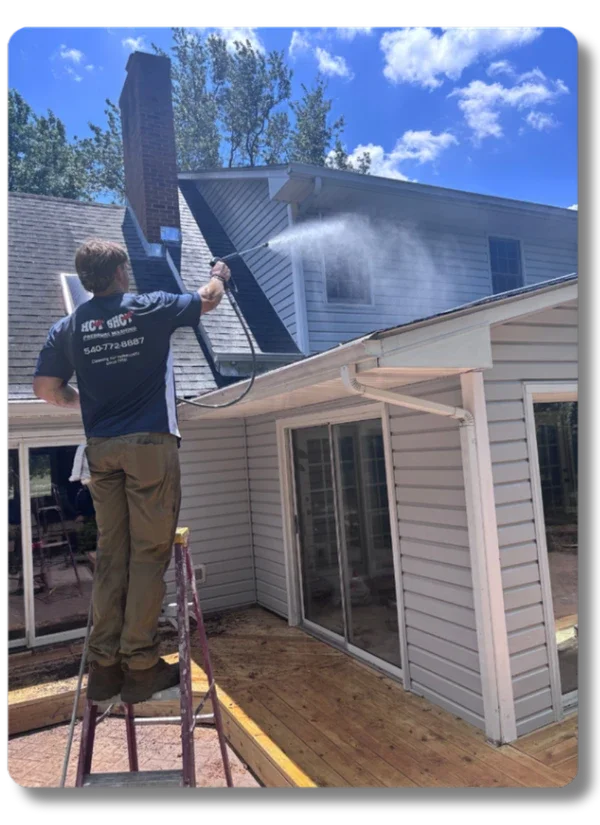 Hot Shot Pressure Washing technician cleaning residential windows on a house exterior in Roanoke Valley VA