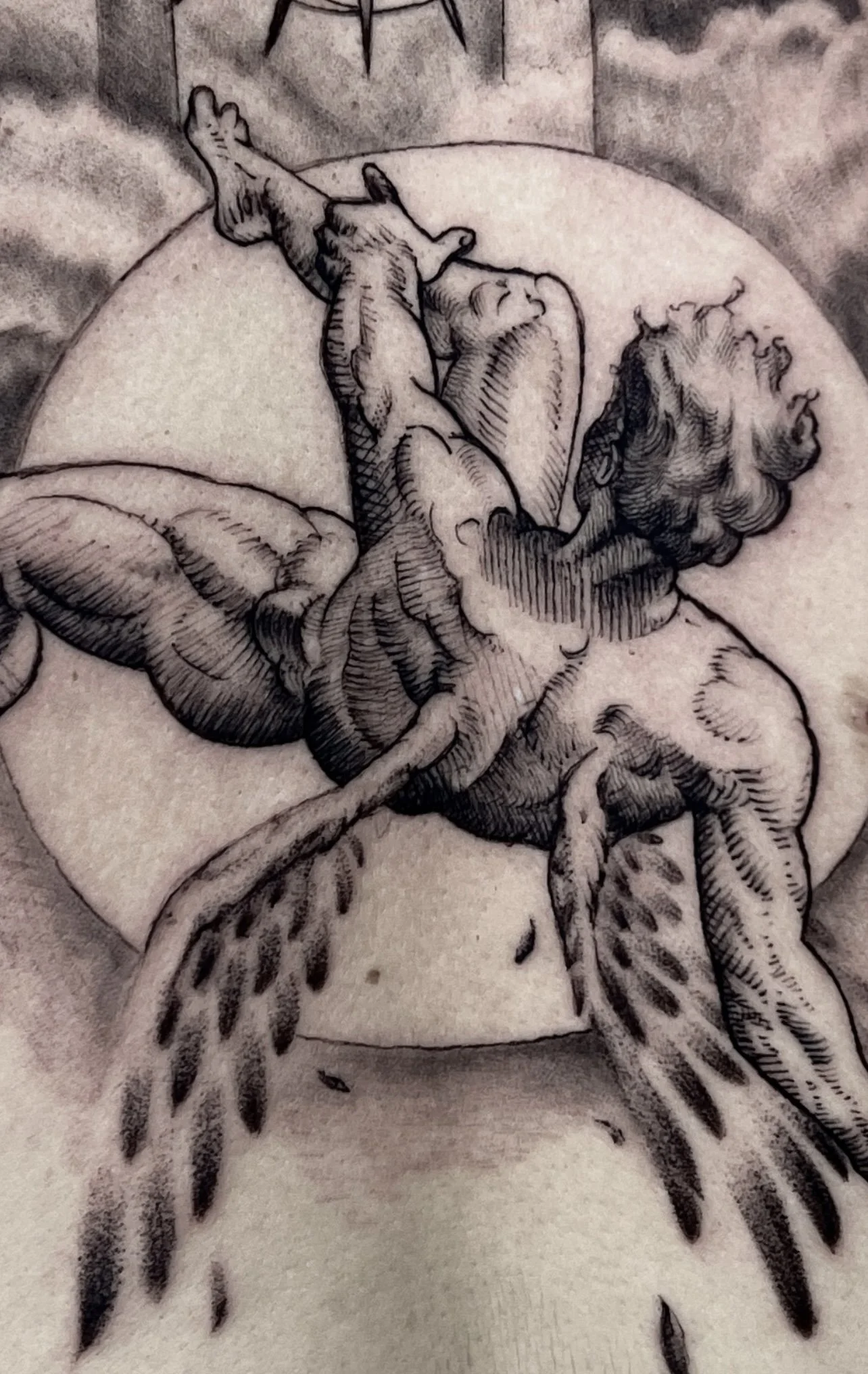 Black-and-gray falling angel back tattoo at Black Craft Tattoo Collective in Charlotte, NC.