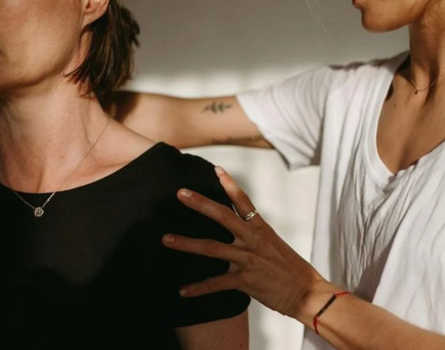 Therapist assessing a client’s shoulder